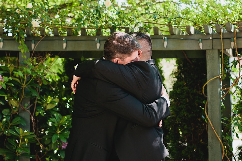 grooms hugging at abigail's hotel wedding ceremony