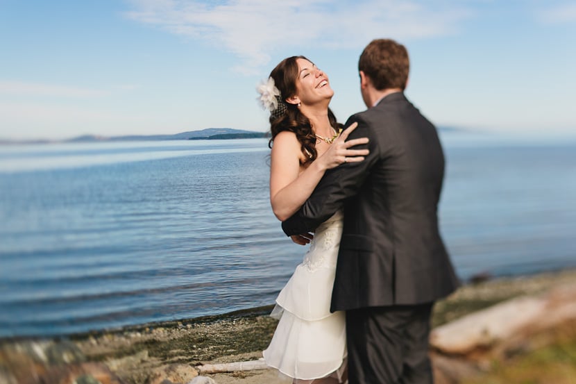 laughing bride at oceanfront beach