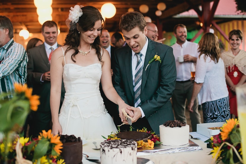 silly bride and groom cut cake in victoria bc