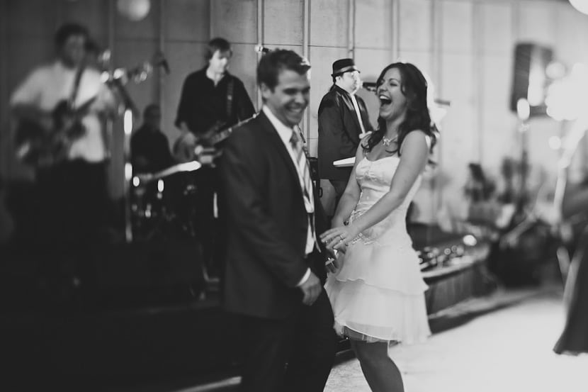 bride and groom laughing during wedding reception