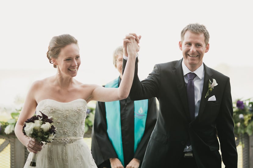 bride and groom cheering after wedding ceremony