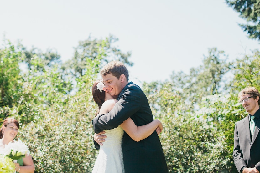 bride and groom hug during wedding ceremony