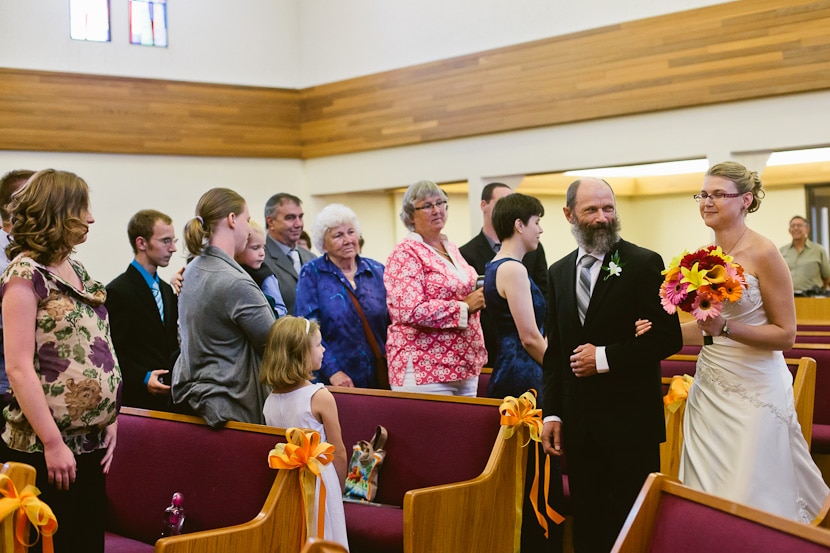 bride's father walking her down the aisle during wedding ceremony