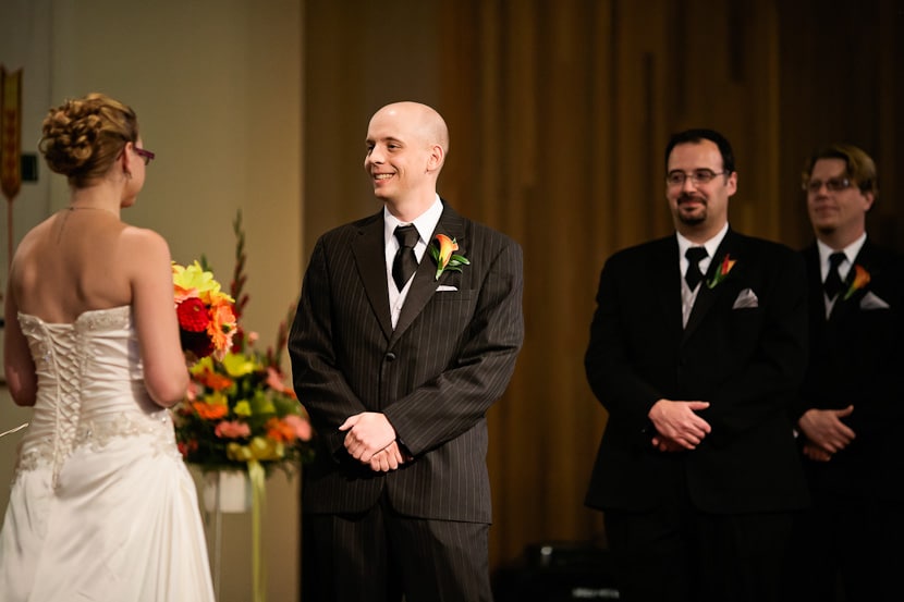 groom smiles during wedding ceremony in victoria bc