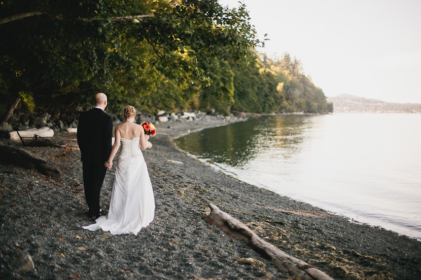 bride and groom walking away on beach in victoria bc