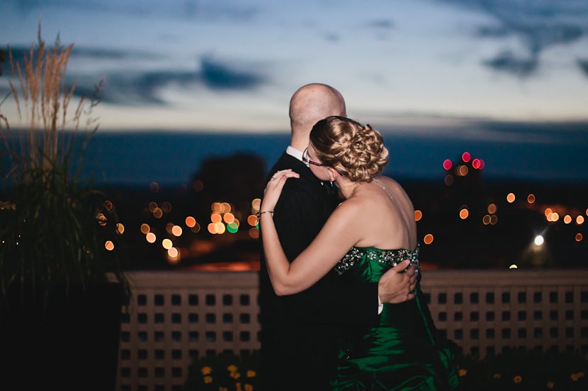 bride and groom dance with view of downtown victoria