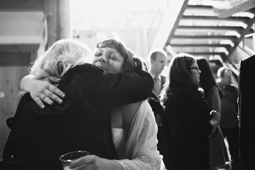 bride hugging relative at wedding reception