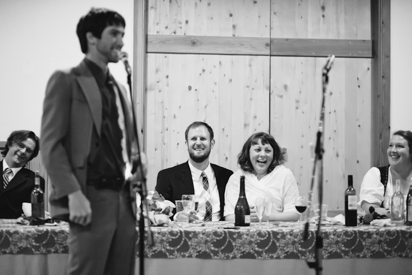 couple laughs at best man's speech at pender island wedding reception