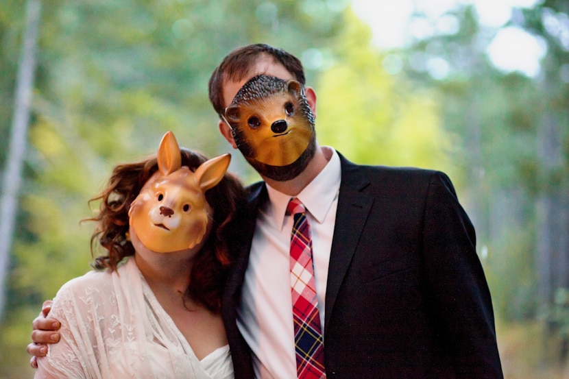 bride and groom wearing animal masks on pender island