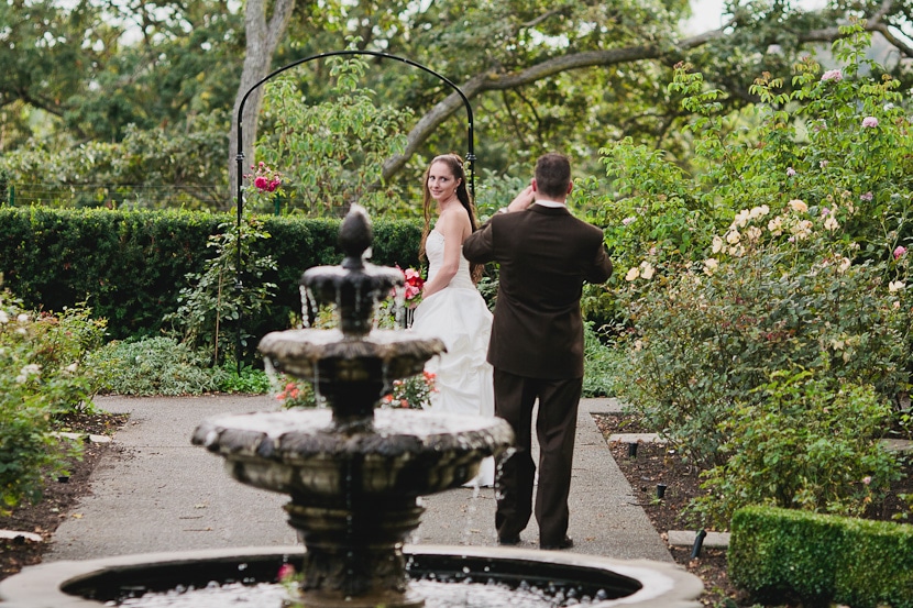 groom taking photos of the bride at government house in victoria bc