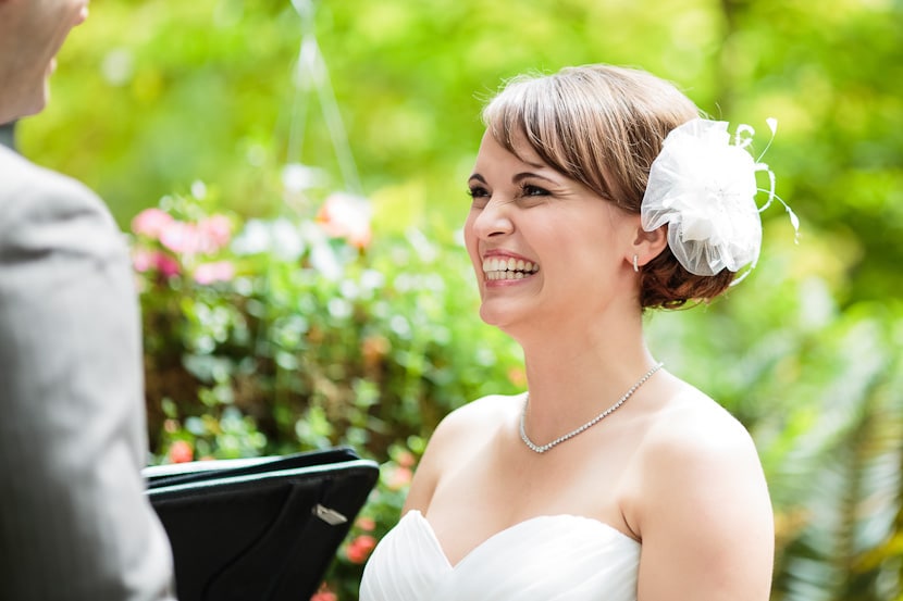 bride smiling during wedding ceremony