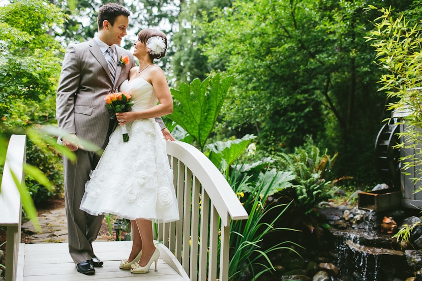 wedding portrait on bridge next to waterfall
