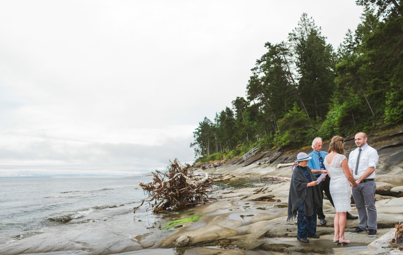 Wedding vows and looks of love on the beach, Galiano Island.  Officiant - Dora Fitzgerald