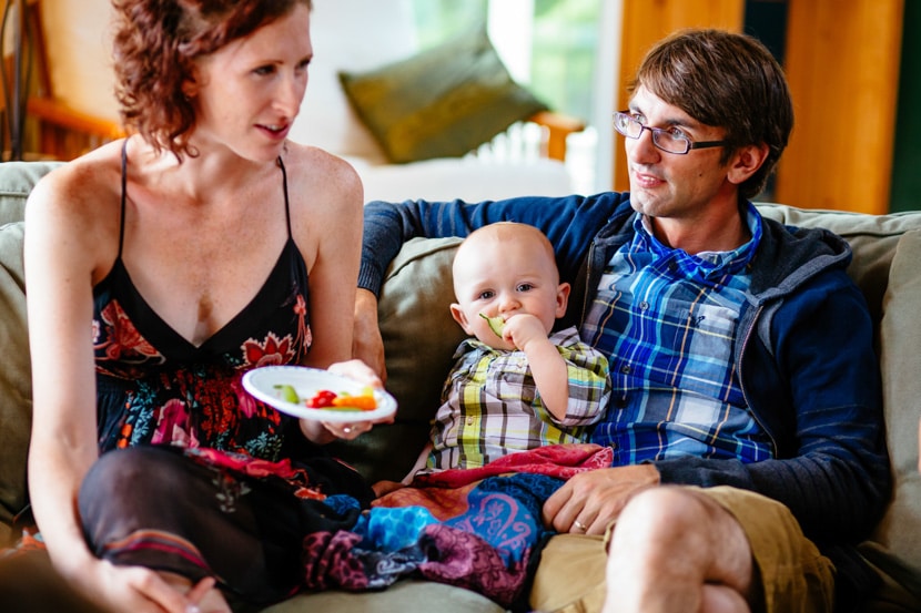 Baby boy sits between two guests, enjoying the delicious food!
