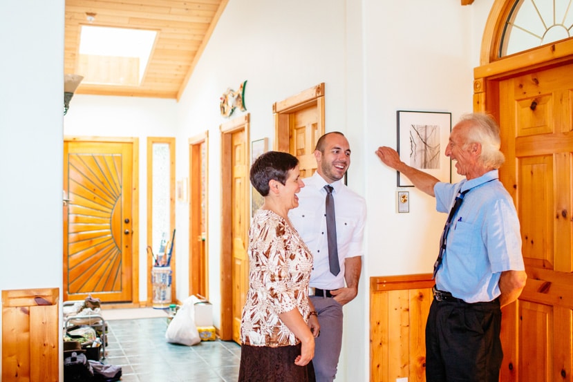 Guests share some laughter with the beaming groom