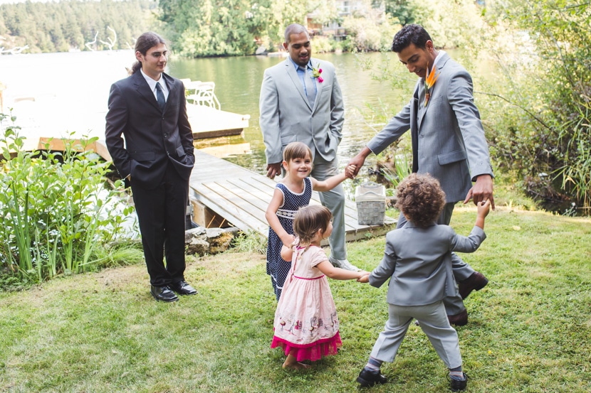 kids playing with groom at backyard wedding