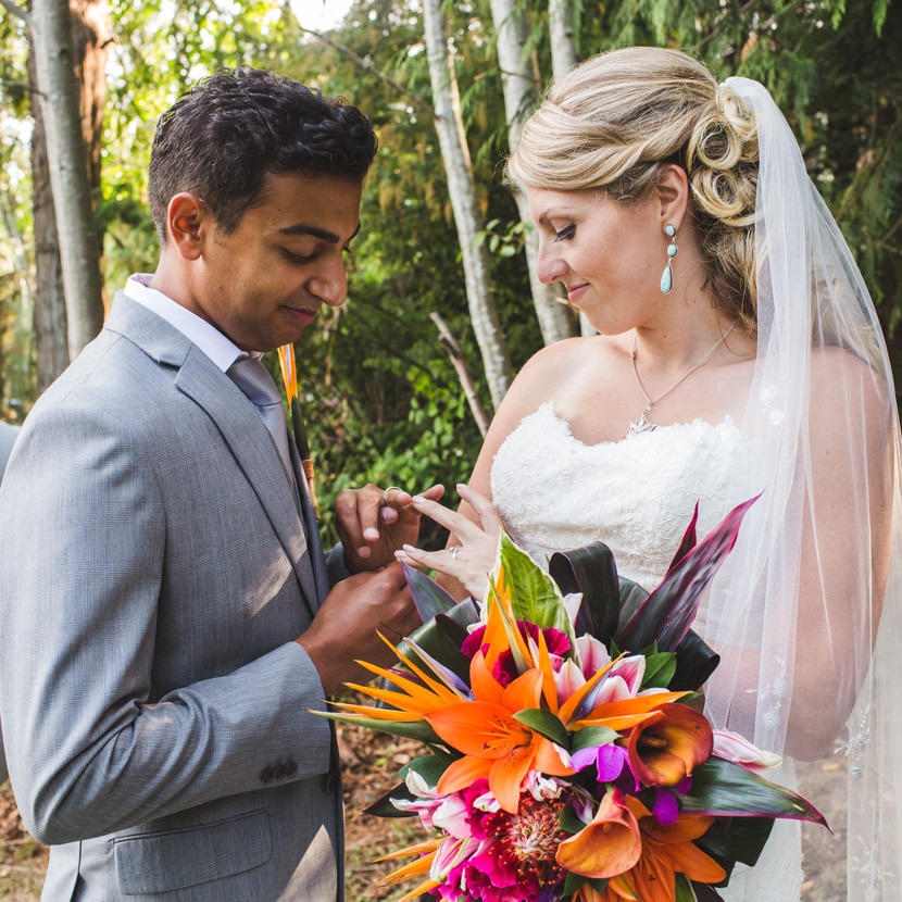 bride and groom looking at rings