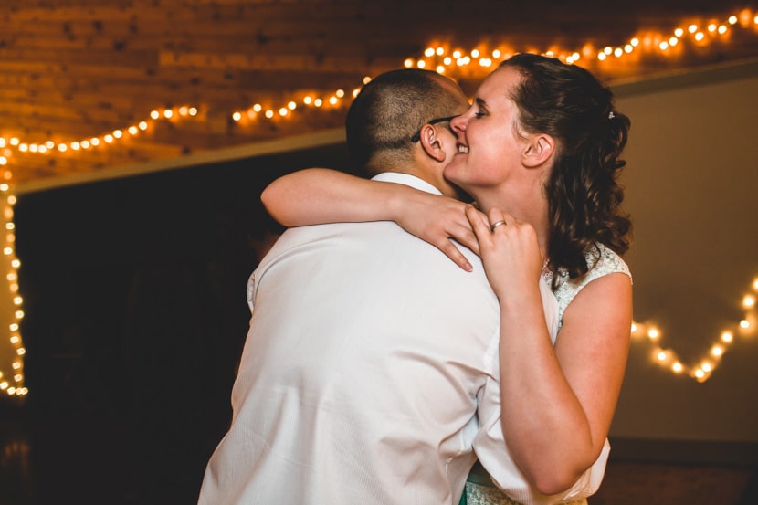 bride and groom hug during wedding dancing