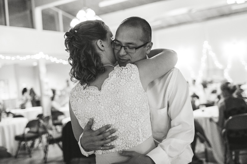 intimate hug between bride and groom at wedding reception