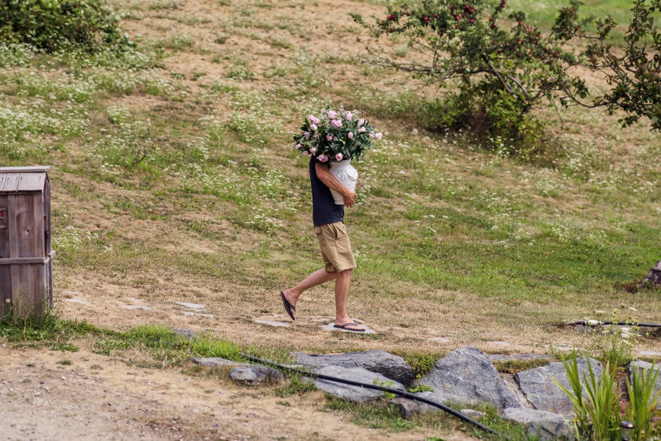 bride's brother carrying flowers to ceremony