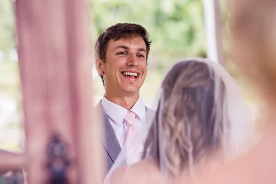 groom laughing during ceremony at merridale cider