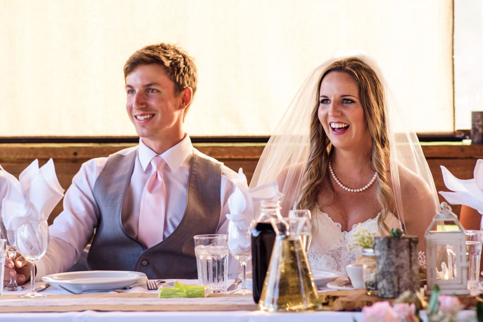 couple laughing at wedding toast