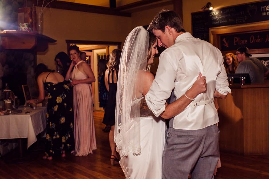 bride and groom cuddling on dance floor