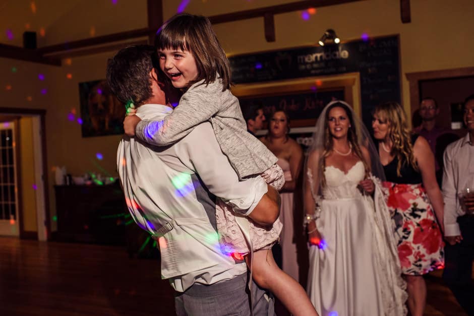 groom dancing with flower girl