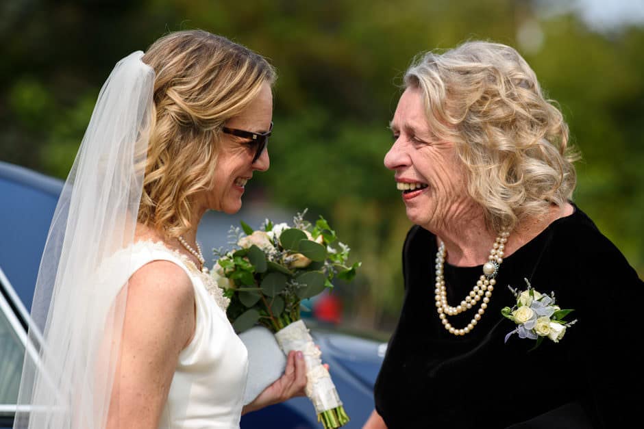 bride and mother share a sweet moment before wedding ceremony