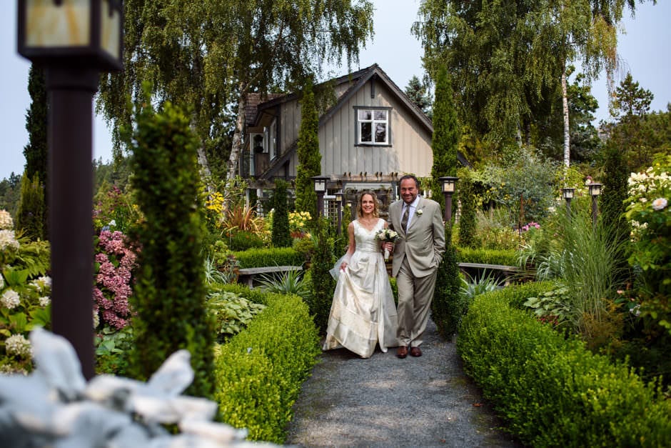 bride's friend walking her through garden at Deep Cove Chalet