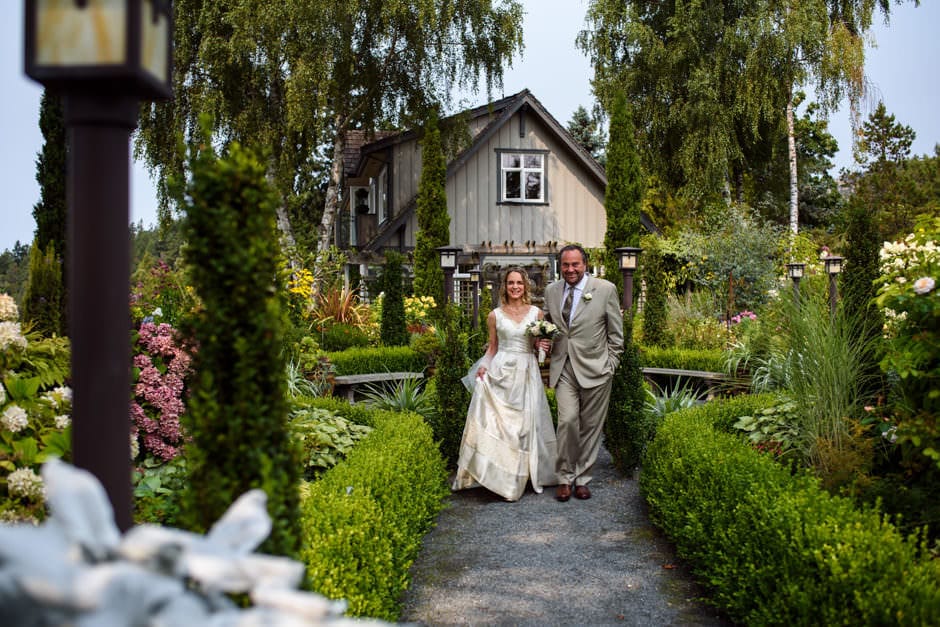 bride's friend walking her through garden at Deep Cove Chalet