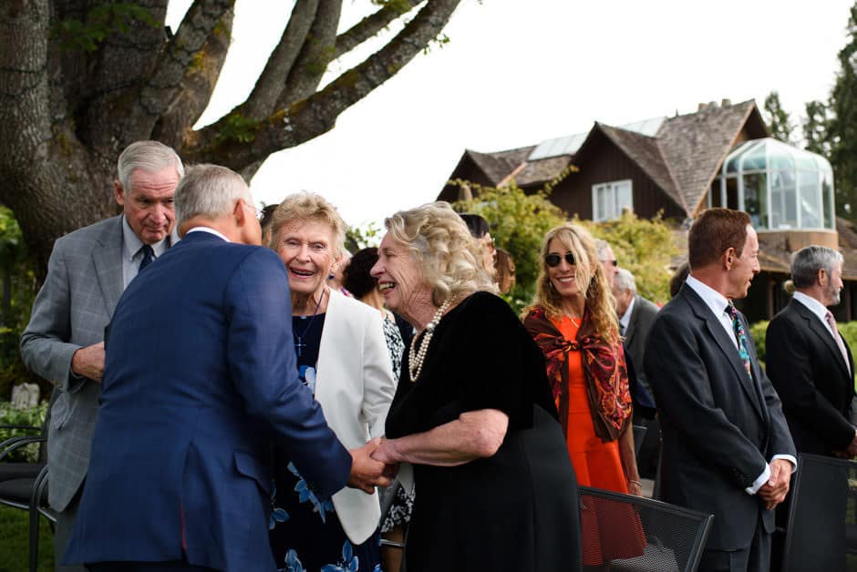 groom greeting parents at wedding ceremony