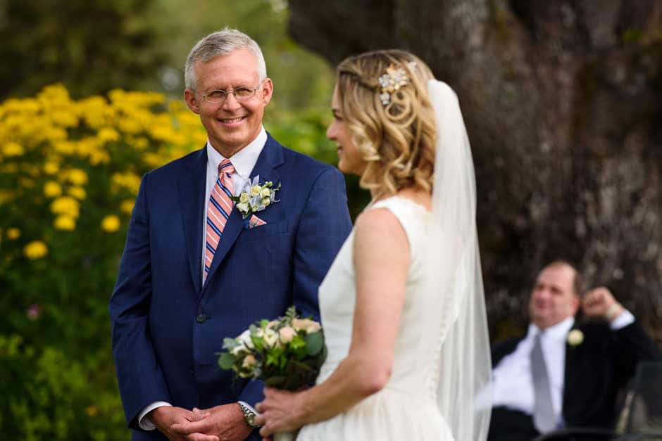 groom smiling during outdoor wedding ceremony
