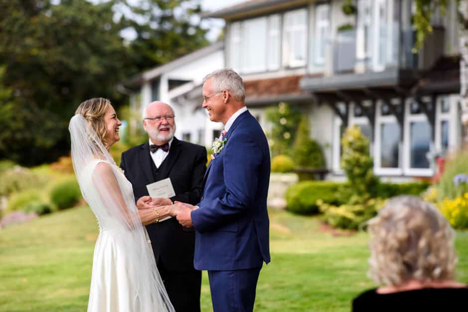 bride and groom laughing during wedding vows