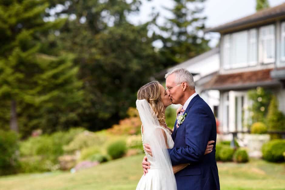 couple kissing at outdoor wedding ceremony