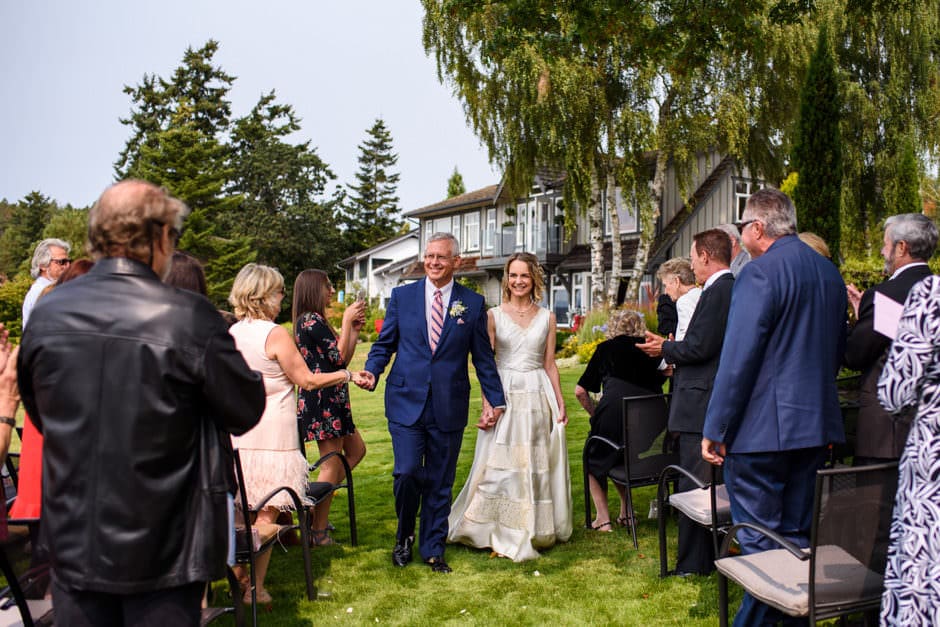 couple smiling during wedding recessional