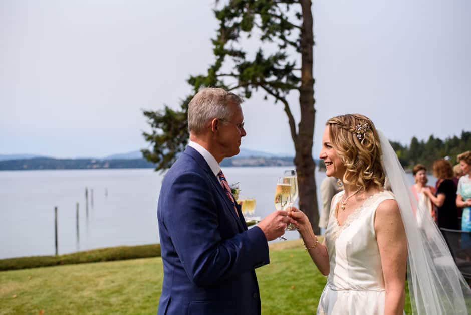 bride and groom toasitng after oceanfront ceremony