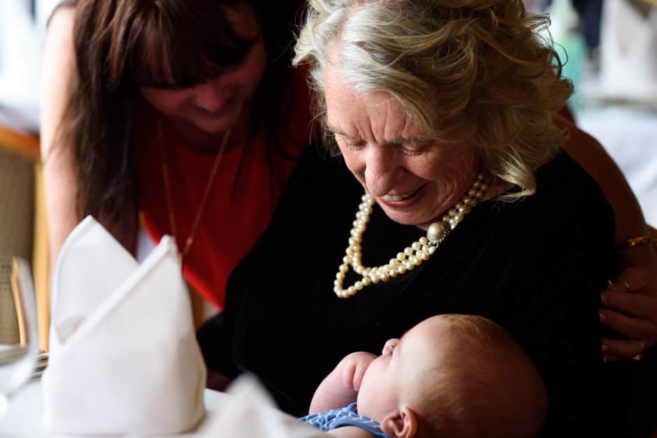 mother of the bride holding a baby