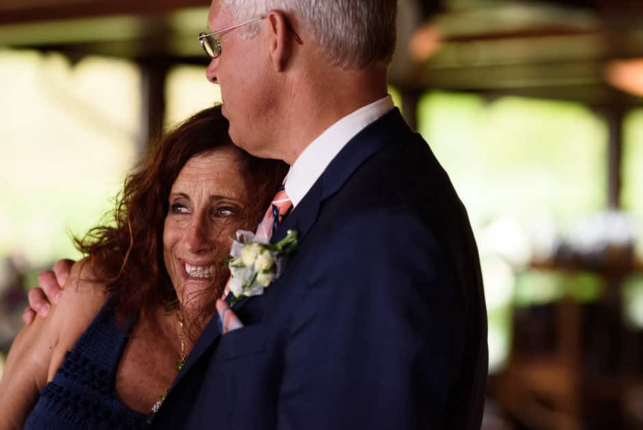 groom hugging a guest at wedding reception