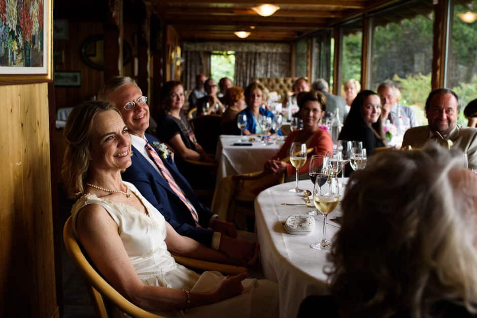 bride and groom listening to toast at deep cove chalet wedding reception
