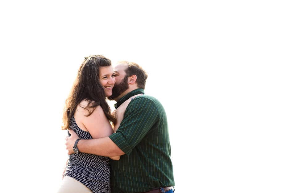 couple snuggling on white background