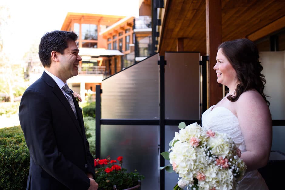 bride and groom having first look on patio