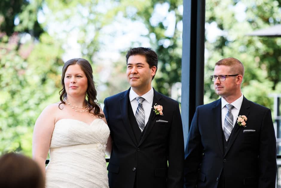 couple and best man listening to wedding reading