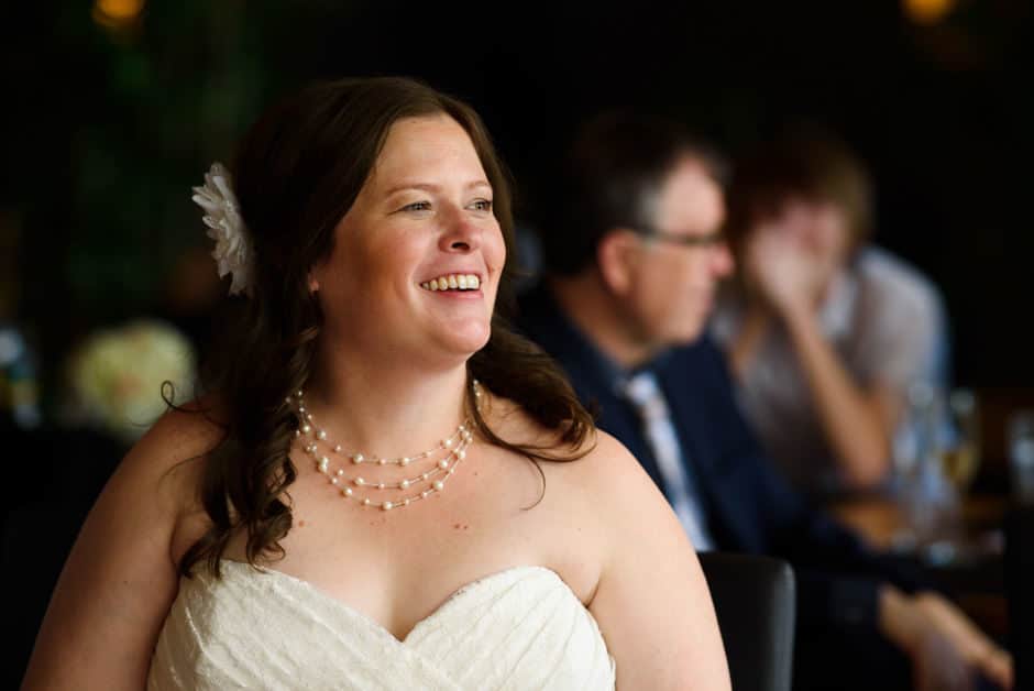 bride laughing at wedding toast