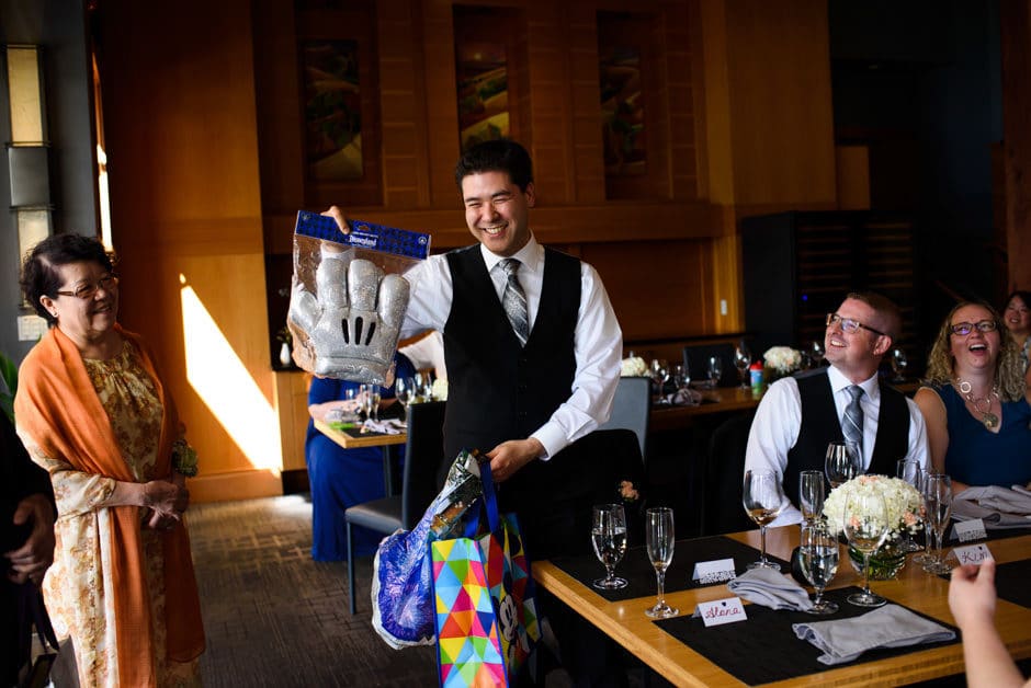 groom receiving mickey mouse gloves as wedding gift