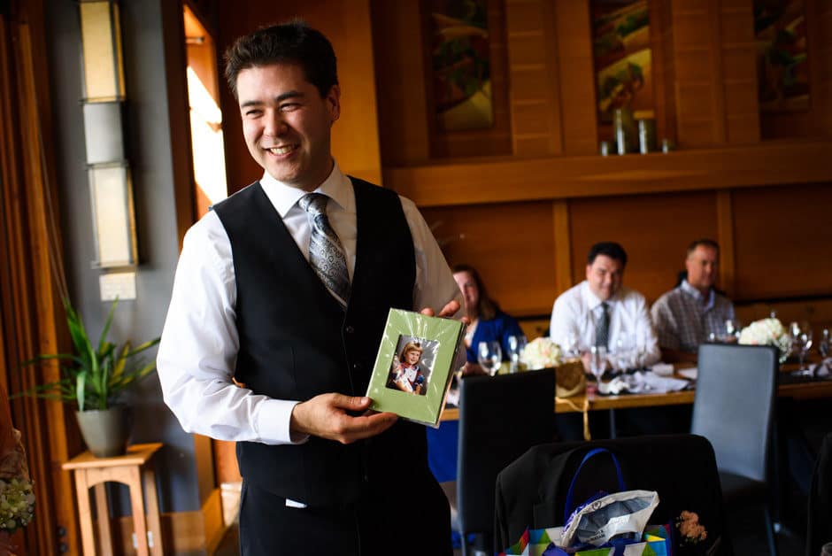 groom holding bride's childhood photo album