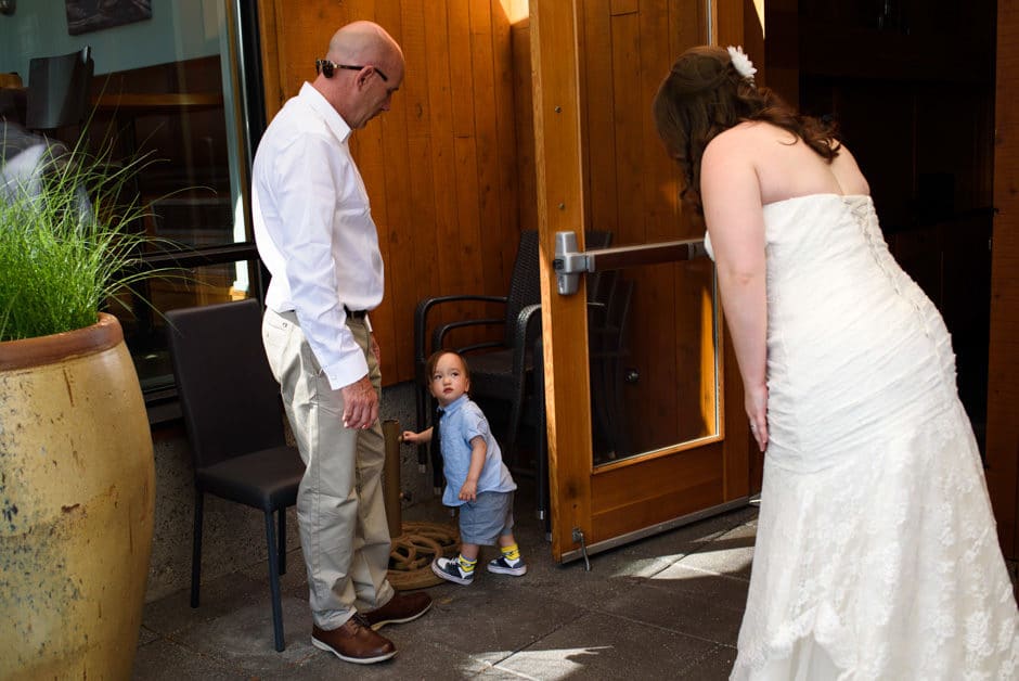 bride greeting shy child