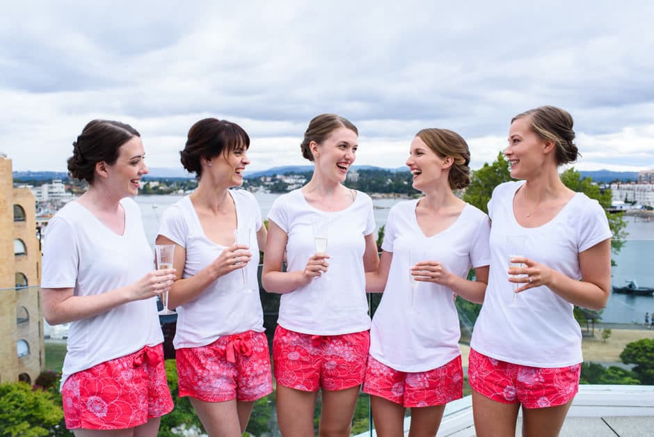 bridal party laughing on balcony at laurel point