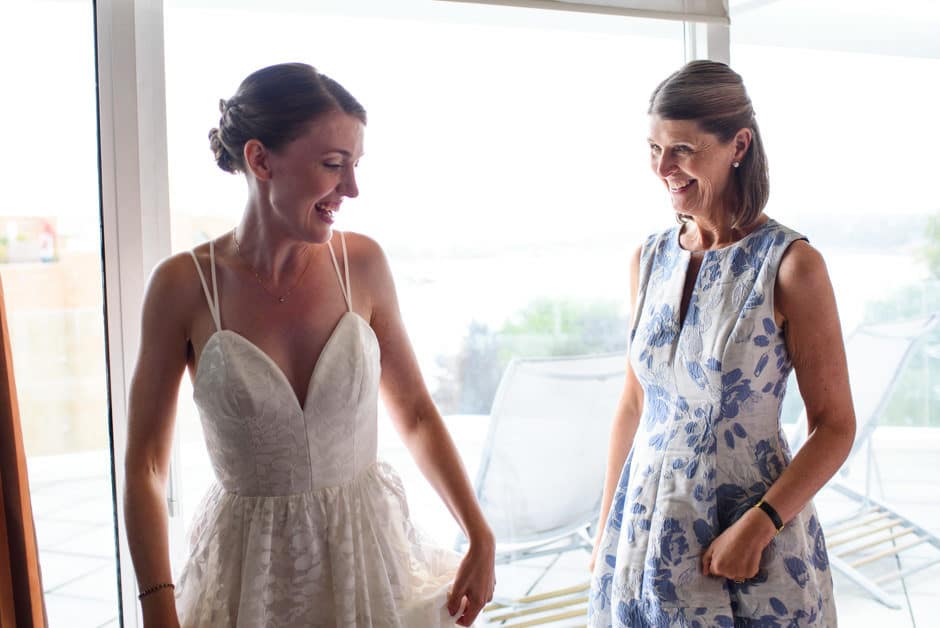 bride and mother laughing at inn at laurel point hotel room