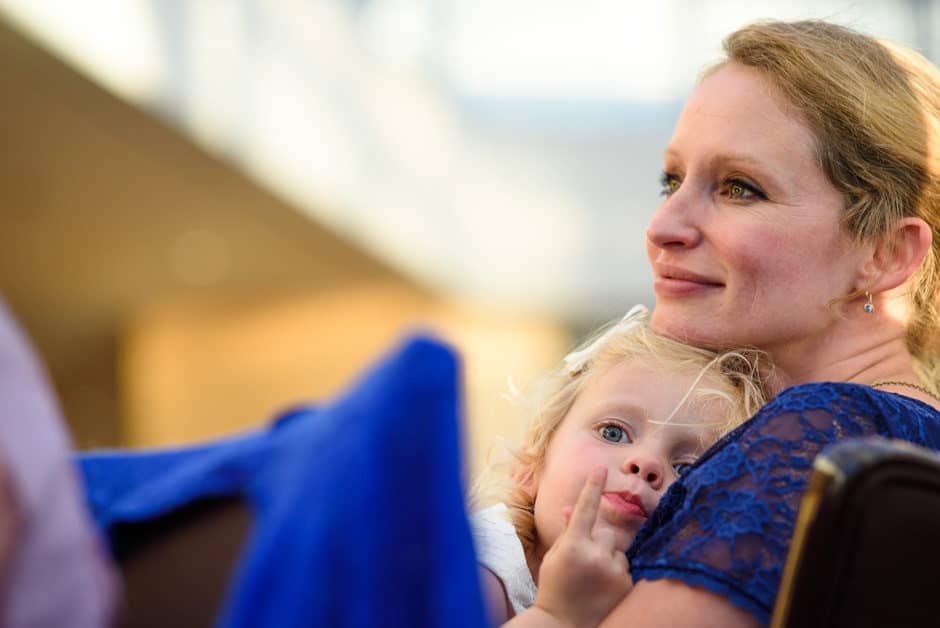 mother holding child during reception